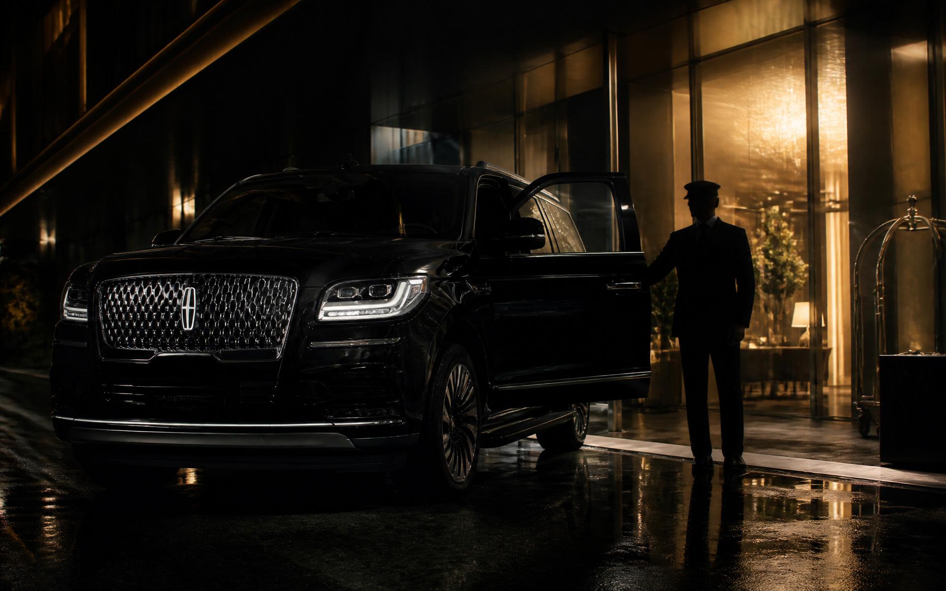 Luxury black Lincoln Navigator with chauffeur at a hotel entrance